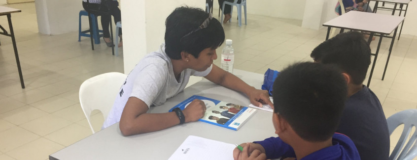  Volunteer to read with a child at Kerinchi Literacy Hub