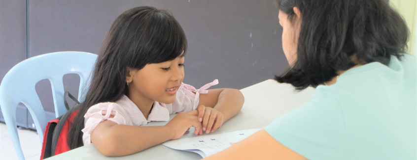 Volunteer to read with a child at Kerinchi Literacy Hub