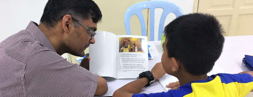 Volunteer to read with a child at Kerinchi Literacy Hub