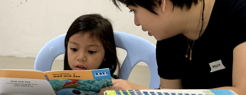 Volunteer to read with a child at Kerinchi Literacy Hub
