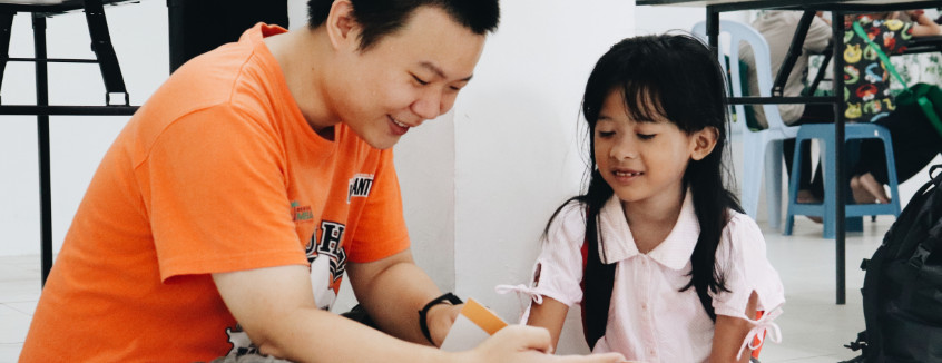 Volunteer to read with a child at Kerinchi Literacy Hub