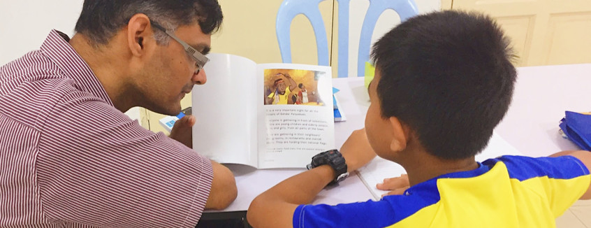 Volunteer to read with a child at Kerinchi Literacy Hub