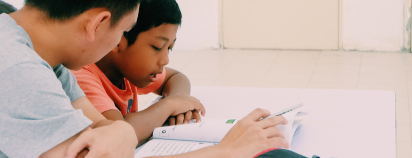 Volunteer to read with a child at Kerinchi Literacy Hub