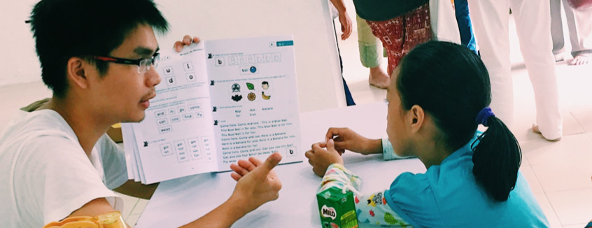 Volunteer to read with a child at Kerinchi Literacy Hub