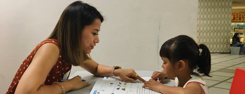 Volunteer to read with a child at Kerinchi Literacy Hub