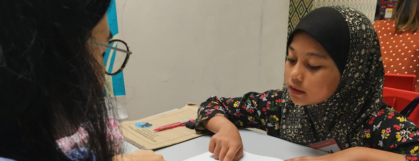 Volunteer to read with a child at Kerinchi Literacy Hub