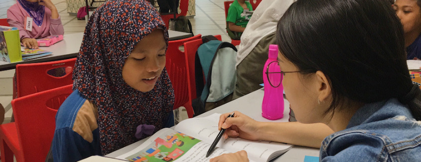 Volunteer to read with a child at Kerinchi Literacy Hub