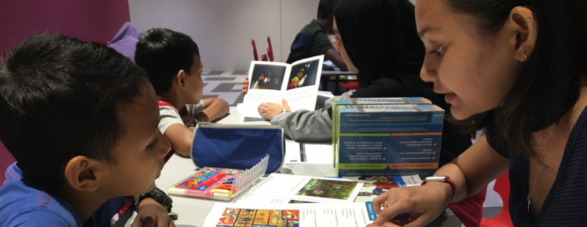 Volunteer to read with a child at Kerinchi Literacy Hub