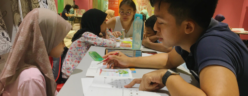 Volunteer to read with a child at Kerinchi Literacy Hub